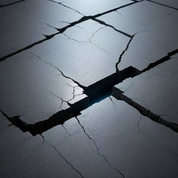 crack in the ground with a light shining through it and a crack in the ground with a light shining through it