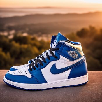 pair of blue and white sneakers on a ledge with a view of the mountains in the background at sunset