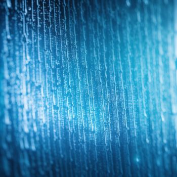 close up of a rain covered window with drops of water on it and a blue background with a blurry image of a building