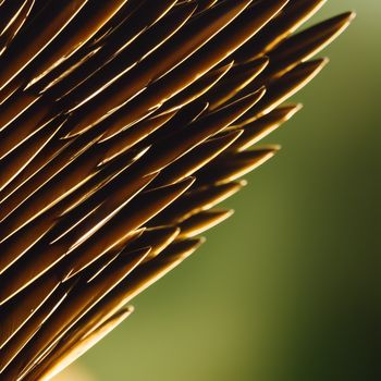 close up of a bunch of brown sticks with a blurry background of green and yellow colors in the background