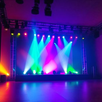 stage with lights and a stage set up for a concert or show with a purple background and a purple background