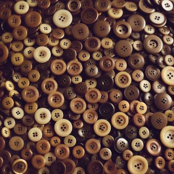 pile of buttons sitting on top of a table next to each other on a table top with a white cloth