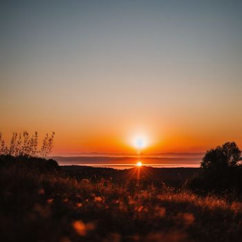 the sun is setting over a large body of water in the distance