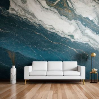 white couch sitting in front of a wall with a painting on it