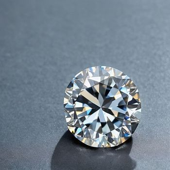 round brilliant cut diamond sitting on top of a gray table top